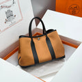 HERMES GARDEN PARTY 30CM IN ORANGE MINIMUM TOILETS COTTON CANVAS AND BLACK CALFSKIN